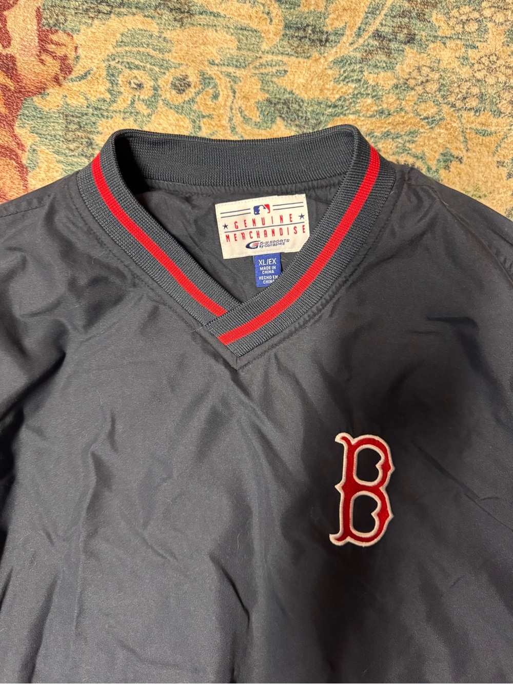 Genuine Merchandise Men's Navy V-Neck Pullover with Red Trim and Red/White Patch